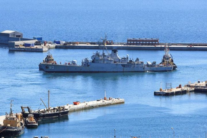 A wide view of the Simon’s Town naval base featuring a Chinese destroyer and an Iranian corvette docked together under the Cape Peninsula mountains